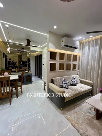 A complete view of a living and dining area, showing how different elements like the sofa, dining table, and mirror wall come together to create a cohesive design.