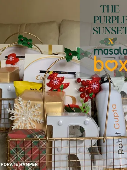 A festive corporate hamper for Masala Box, featuring personalized initial marquee lights and custom-branded water bottles in a beautiful wire basket.