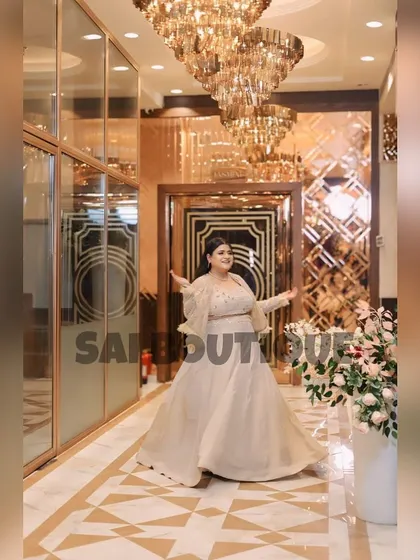 A grand entrance in a custom off-white gown. The structured top and flowing skirt create a princess-like feel, perfect for a milestone birthday or engagement party.