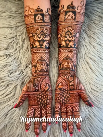 This design is a perfect example of royal Rajasthani mehendi, with peacocks, elephants, and jharokhas covering the hands.