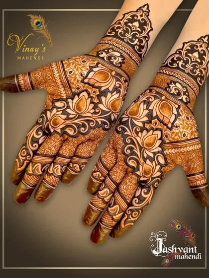 A bold and beautiful design dominated by large lotus motifs on the back of the hands. The use of negative space makes the flowers pop.