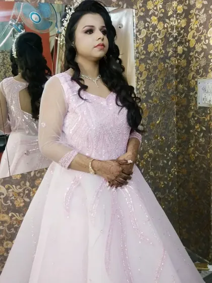 Another angle of the engagement bride in her pink gown. The makeup is soft and romantic, with a focus on glowing skin.