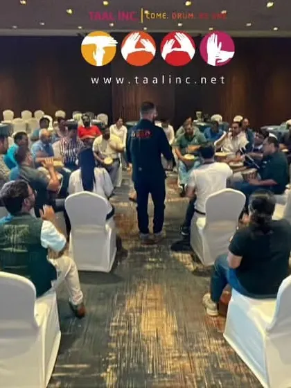 This photo captures the essence of a corporate drum circle: a group of individuals, initially strangers or just colleagues, becoming one unified entity through rhythm. It's team building in its most fundamental form.