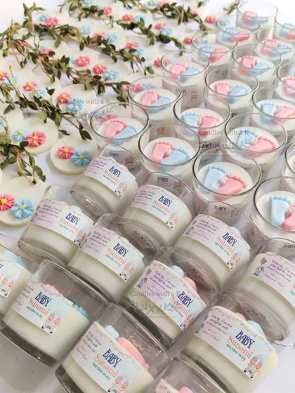 An array of baby feet votive candles and floral wax sachets, showcasing the delicate handmade details for a baby shower order.