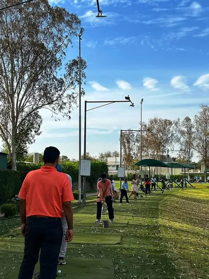 A coach watches over a student on the range, providing guidance and support.
