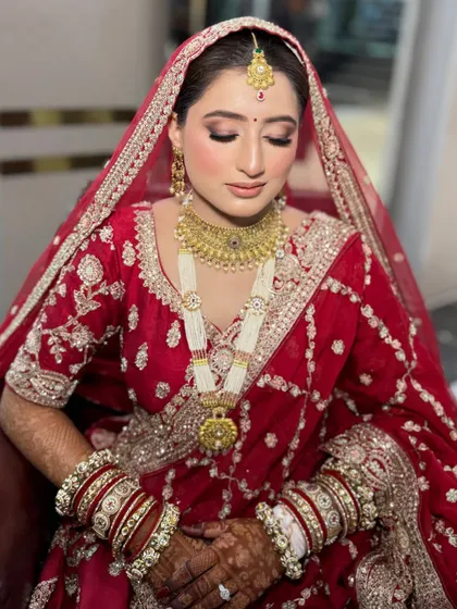 A beautiful close-up showing the bride's soft, shimmery eye makeup and perfectly matched lip color. The entire look is elegant and timeless.