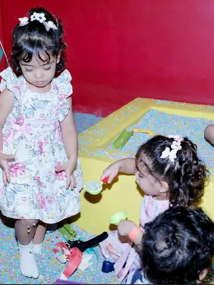 Younger guests can enjoy our special play areas, like this enclosed sand pit with colorful toys.