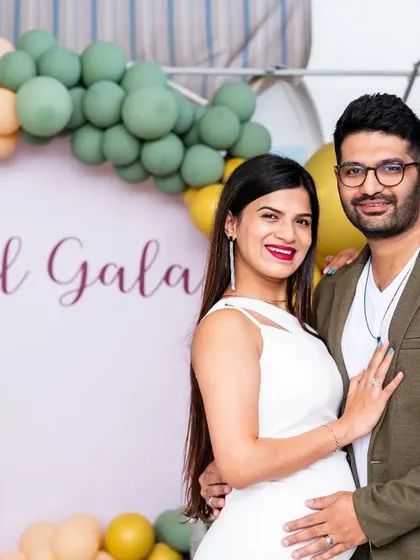 A classic portrait of the expecting couple at their baby shower. They look so happy and stylish, and it's a wonderful memory of the celebration before their little one arrives.
