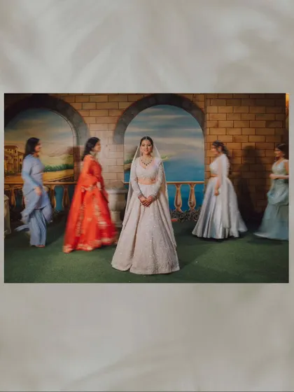 A creative shot of the bride with her bridesmaids blurred in motion around her, making her the calm center of the moment.