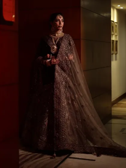A full-length shot showcasing the bride's complete look. The makeup harmonizes with her grand lehenga for a truly regal appearance.