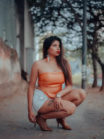 A low-angle shot that creates a powerful and confident pose. The urban setting and the model's outfit are perfect for a street fashion lookbook.