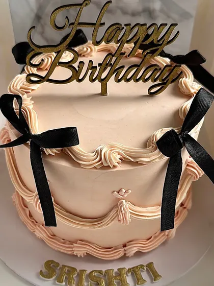 This personalized vintage birthday cake features delicate piping and black satin bows, all beautifully presented in one of my signature cake boxes.
