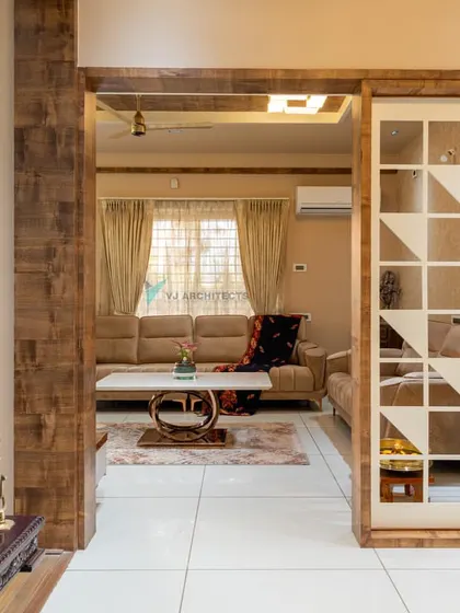 This custom-designed geometric partition separates the living and dining areas while maintaining a sense of openness. The pattern is a modern interpretation of traditional motifs, allowing light to pass through and create interesting shadows.