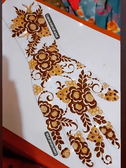A practice sheet showing a beautiful floral Arabic-style design. The swirling flowers and leaves create a sense of movement and elegance.
