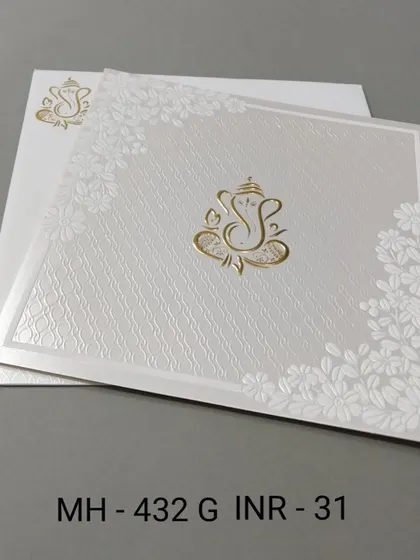 A clean and simple white invitation with a gold Ganesha motif. The textured paper and floral corners add a touch of elegance to this budget-friendly card.