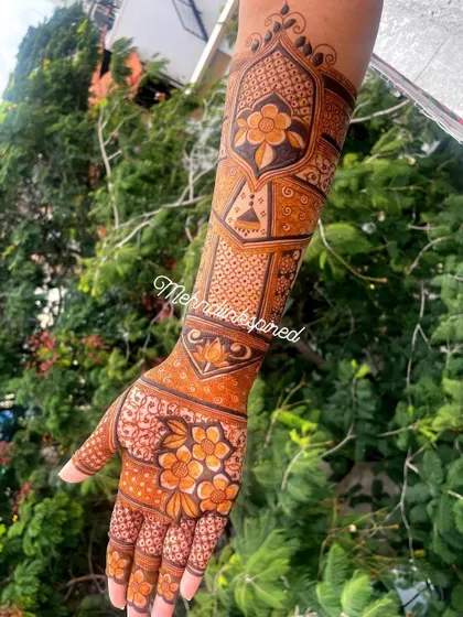 A lovely floral bridal design extending up the arm. The mix of bold flowers and delicate filler patterns creates a balanced and beautiful look for the bride.