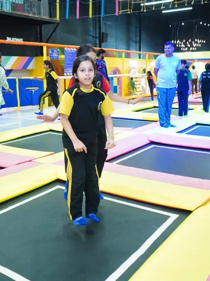 A student gets her bounce on in the main trampoline court during a school trip.