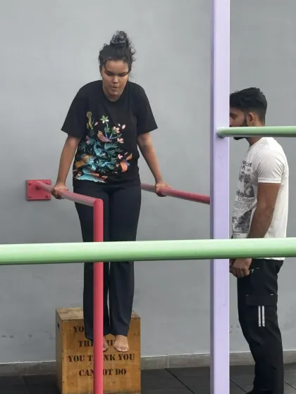 We ensure everyone, regardless of their starting point, feels confident and capable. Here, a member works on her dip progression with a coach right by her side, offering encouragement and ensuring her technique is safe.