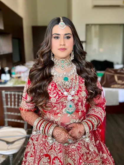 This bride's look was all about embracing royal vibes. The makeup was designed to be elegant and timeless, with soft contouring and a neutral lip to balance the heavy jewelry.