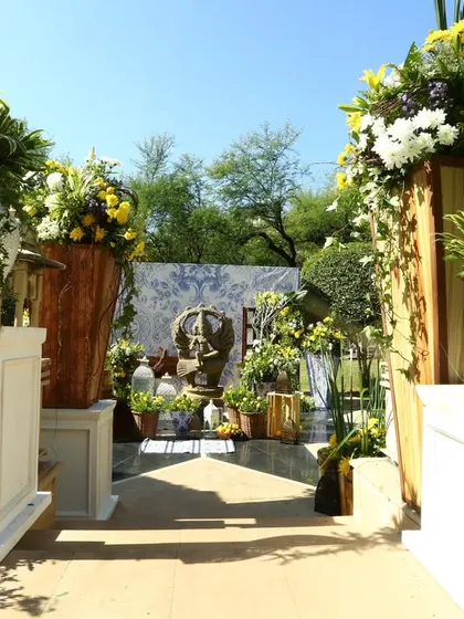 The entrance to a garden wedding in Rajasthan, adorned with fresh flowers and traditional decor elements.