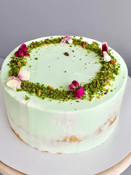 This Pistachio White Chocolate Naked Cake is all about delicate flavor and satisfying texture. The soft pistachio sponge is layered with a silky pistachio white chocolate ganache and a sprinkle of nougatine for a delightful crunch.