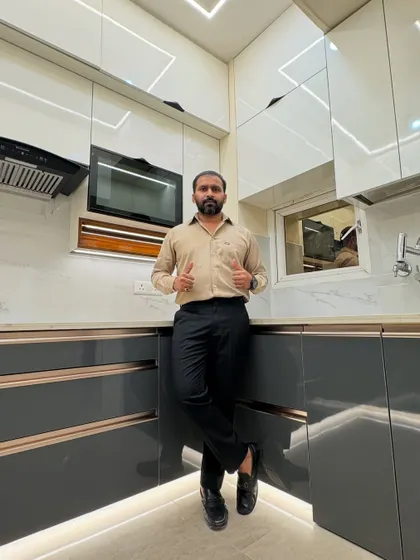 Standing proud in a newly completed luxury kitchen. This U-shaped design features a two-tone scheme with dark grey and high-gloss white cabinets, complemented by profile lighting on the ceiling and skirting.