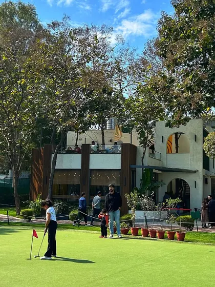 A father and daughter enjoying a putting lesson together. Our space is perfect for family gatherings and creating lasting memories across generations.