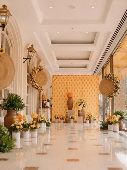 The entrance corridor lined with traditional terracotta vases, pickle jars, and an abundance of yellow and orange marigolds.