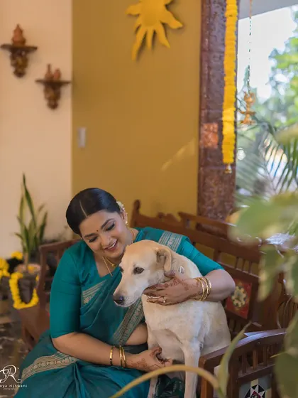 Another sweet moment between the bride and her furry friend at her intimate Goa wedding.