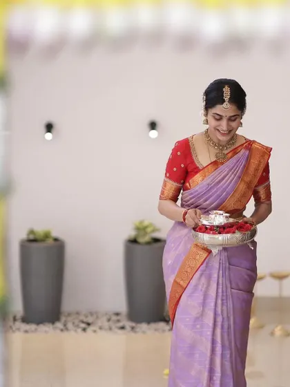 Another shot of the bride during her housewarming ceremony, her smile as bright as her outfit.
