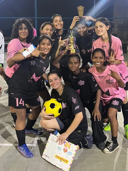 All smiles with the trophy. The team celebrates their victory in the Decathlon 4v4 competition, a testament to their skill in smaller formats and their strong team bond.
