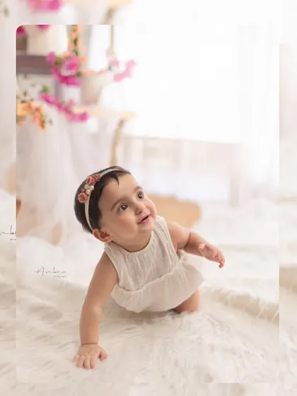 A baby girl crawling towards the light during her sitter session. The beautiful backlighting creates a glowing, ethereal effect in this sweet portrait.