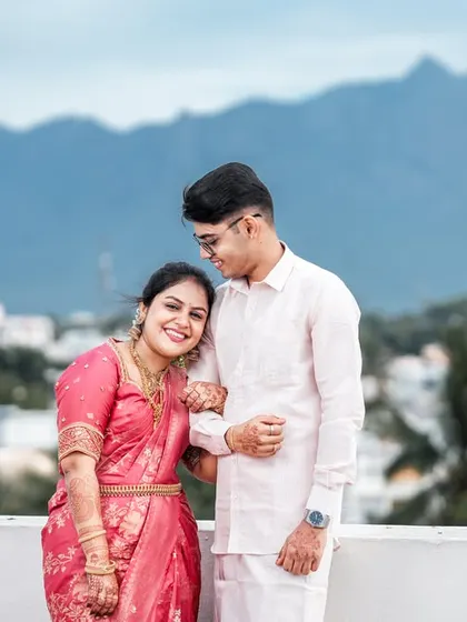 A beautiful post-ceremony portrait on a rooftop in Coimbatore, with the Western Ghats creating a stunning natural backdrop.