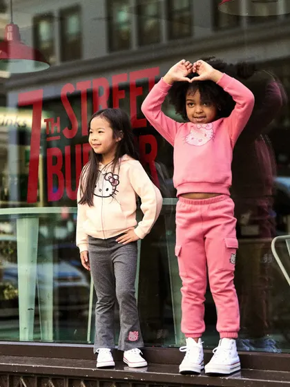 Another shot from the storefront series. The heart gesture adds a playful element, and the reflection in the window adds depth to the image.