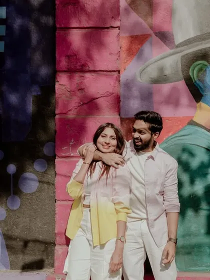 A creative shot with a reflection, blending the couple with the colorful street art.