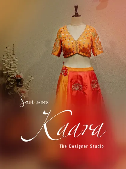 A complete look at our orange and red lotus-motif lehenga on a mannequin. This view highlights the contrast between the embroidered blouse and the flowing, dual-toned skirt, showcasing a perfect blend of color and craft.