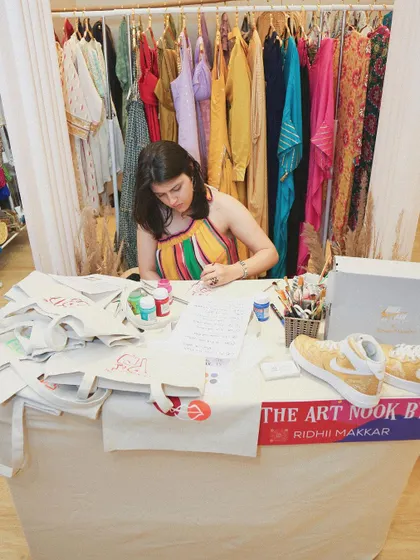 A wider shot of my setup at the Project Tete-a-Tete event. I was busy all day painting custom designs on tote bags for shoppers, creating unique keepsakes for them.