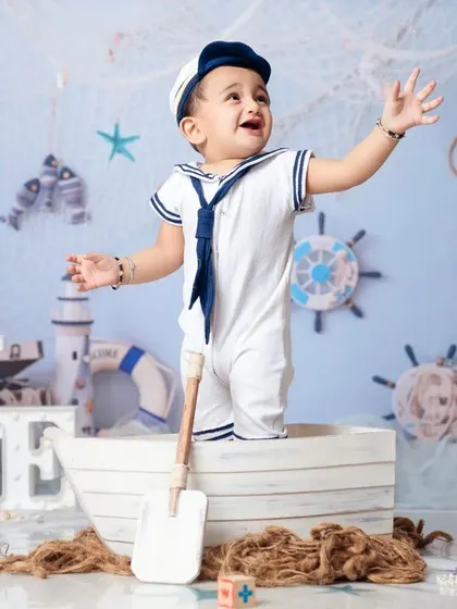 Ahoy, matey! This little sailor is ready to set sail for his first birthday adventure in our nautical-themed setup.