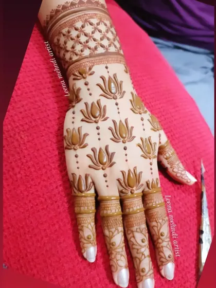 Another angle of the repeating lotus pattern, showing the cuff detail. In my classes, you'll learn how to create these patterns and ensure they flow naturally on the hand.