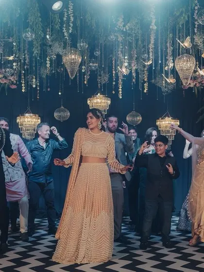 A fun group dance moment at a sangeet, showcasing the lively atmosphere we create with our glamorous decor and lighting.