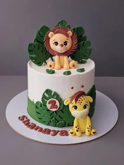 Another take on the jungle theme for Shanaya's second birthday. This chocolate truffle cake features a cute lion and giraffe, perfect for a toddler's celebration.