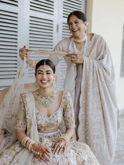 The mother of the bride helping her daughter with her veil. A truly precious moment. I gave her a timeless, elegant makeup look that made her feel confident and beautiful.