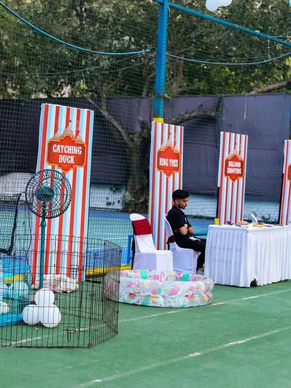 A row of classic carnival game booths, including rabbit feeding, catching ducks, and ring toss, providing endless entertainment for the kids.