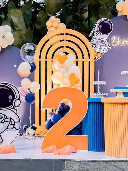 Another angle of the space theme, focusing on the large number '2' and the cute astronaut character sitting on the moon.