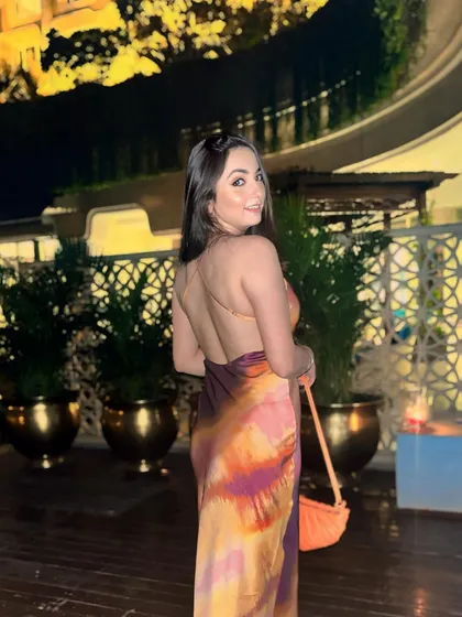 I'd stop scrolling too. A confident pose in the multi-colored tie-dye dress, because sometimes you just know you look good.