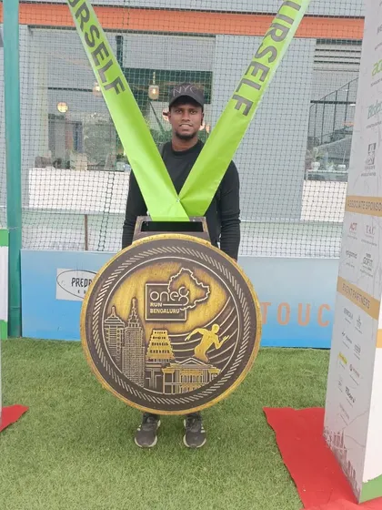 Posing with the giant finisher medal at the One8 Run. A fun memento from a great event.