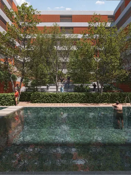 The swimming pool is nestled within the landscaped courtyard, offering a resort-like feel. It's designed as another social hub where residents can relax and interact, surrounded by greenery.