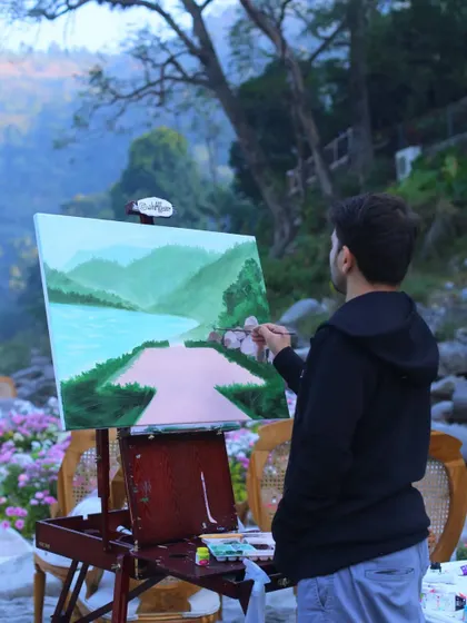 Adding details to the mountains and river in our Rishikesh painting. Getting the landscape just right is key for a destination piece.