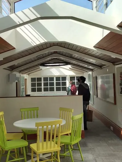 The same attic space seen from another perspective, highlighting the custom shelving and bright, airy atmosphere that encourages collaboration.