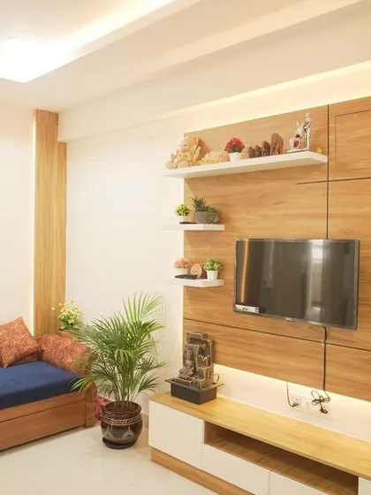 A minimalist TV unit with a wood-paneled back and floating white shelves. The design is clean and functional, providing a perfect backdrop for the entertainment center.